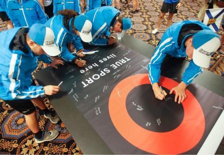 young athletes gather to sign True Sport banner at 2017 Canada Games
