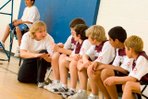 Vicky Mainwood talks to kids in a gym Vicky Mainwood